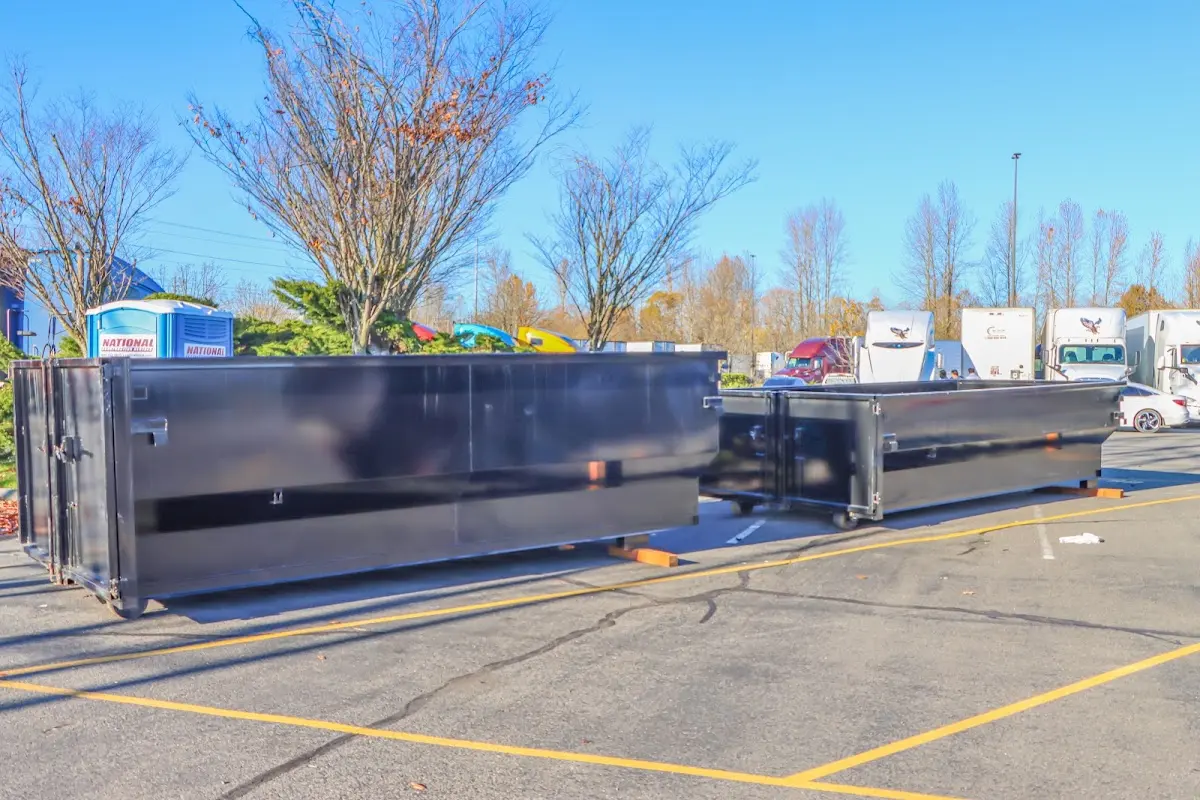 Professional dumpster rental service with roll-off container on residential driveway in Mountain Brook